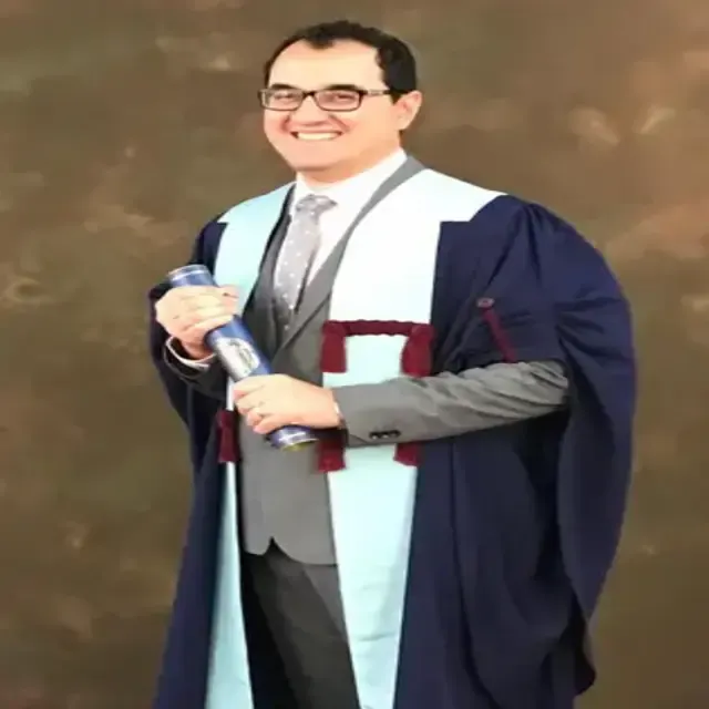 Dr. Ali Khan in graduation robes.